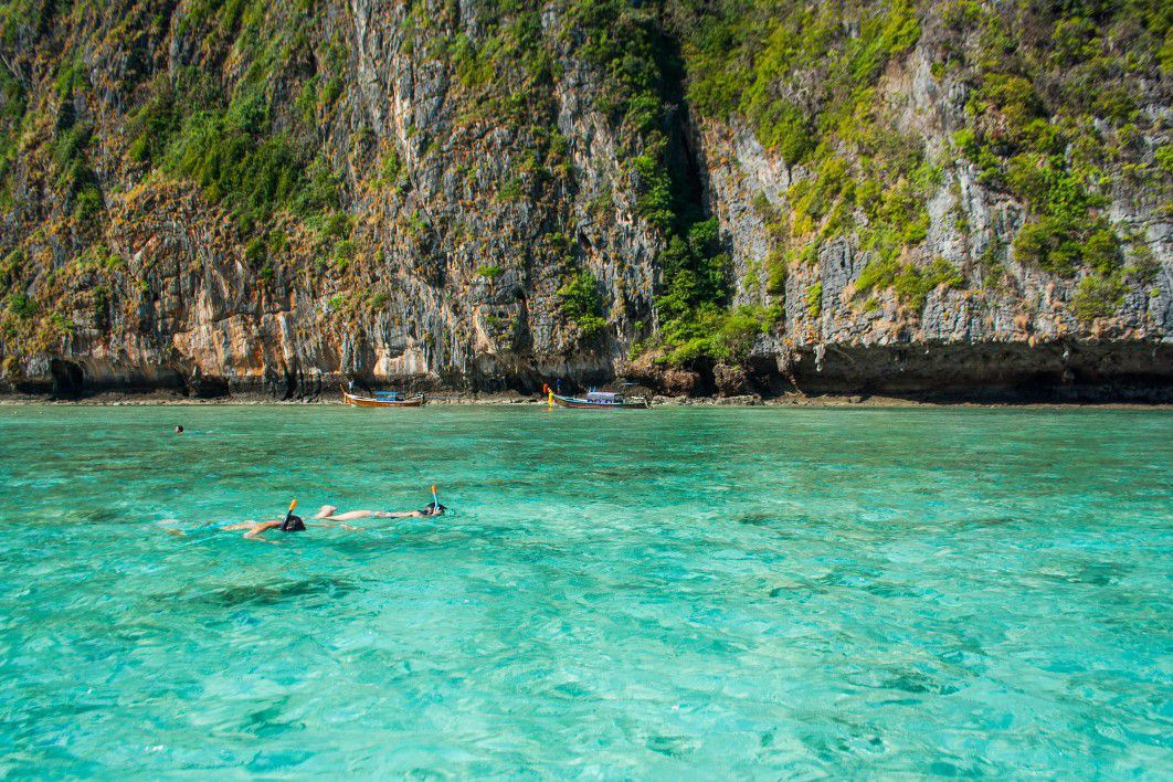 Snorkeler exploring colorful coral reefs in Taniti's clear waters